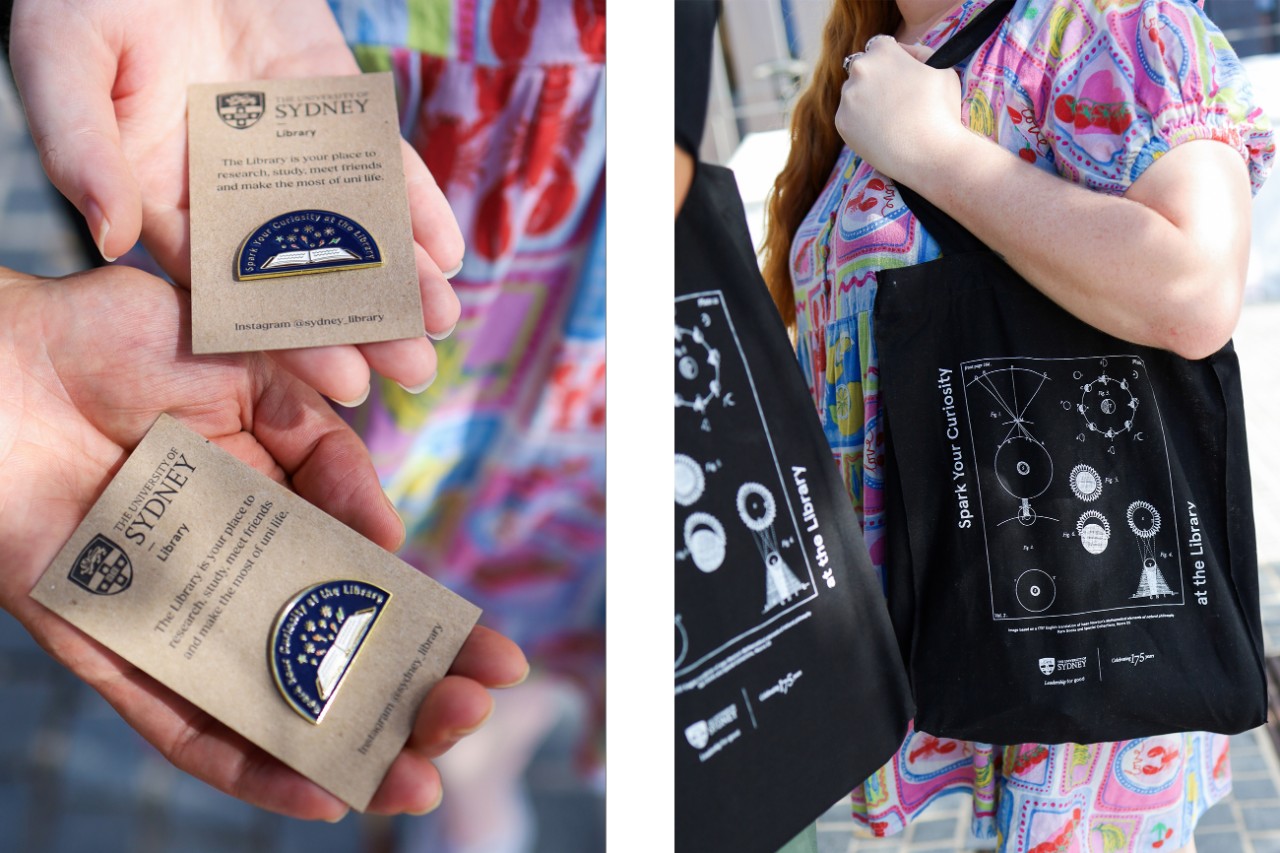 Two people holding Library canvas tote bags