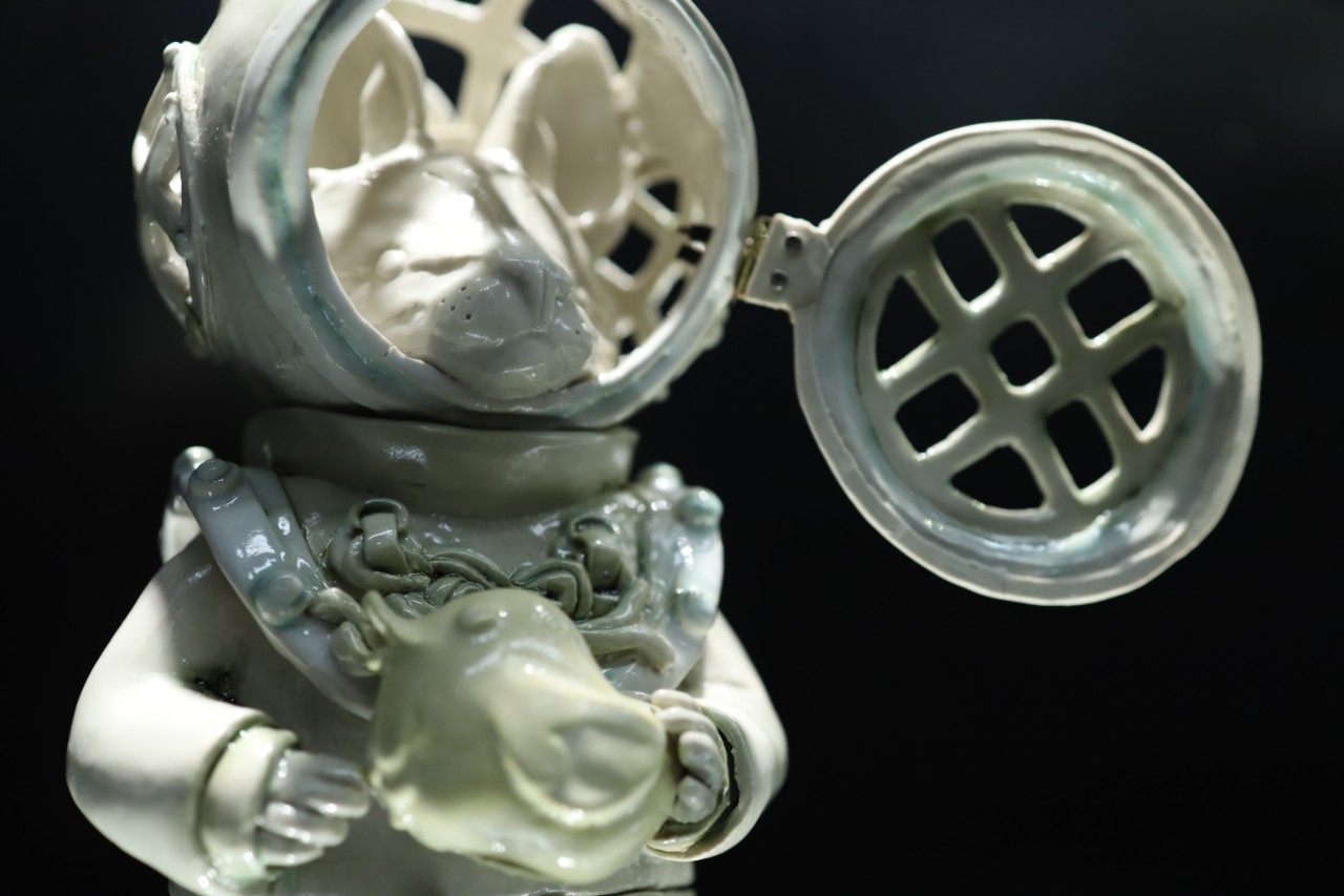 ceramic statue figurine of a cat in an aquanaut suit