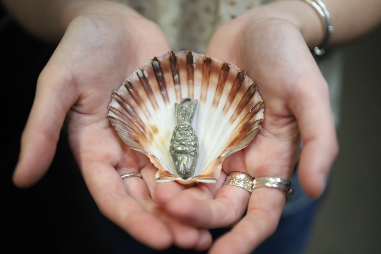 metallic fish in a seashell artwork