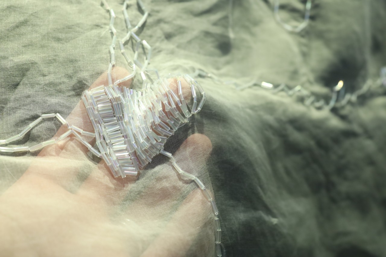 Close up of beads sewn into fabric