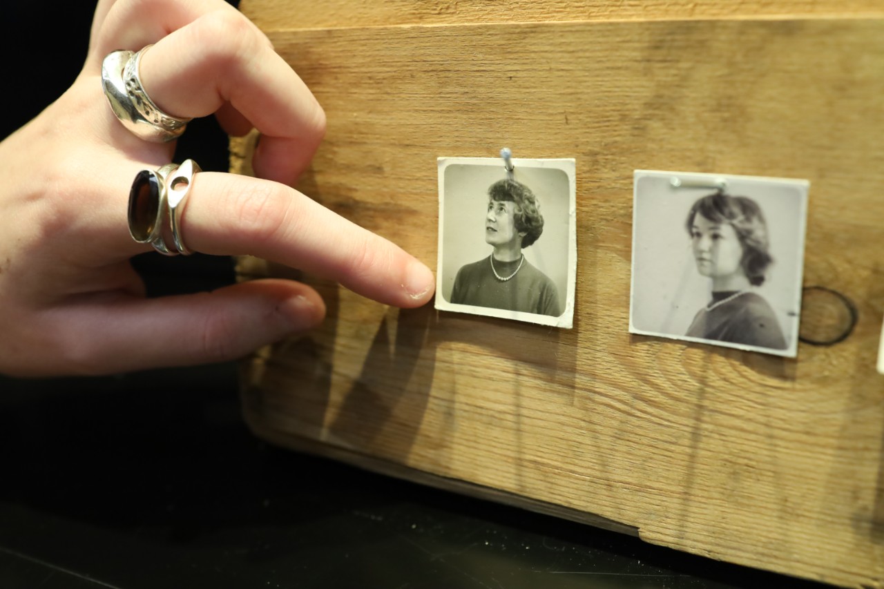 close up of hands touching photograph 