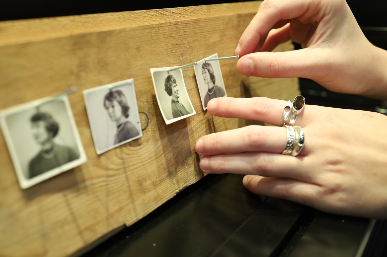 close up of hands touching photographs 