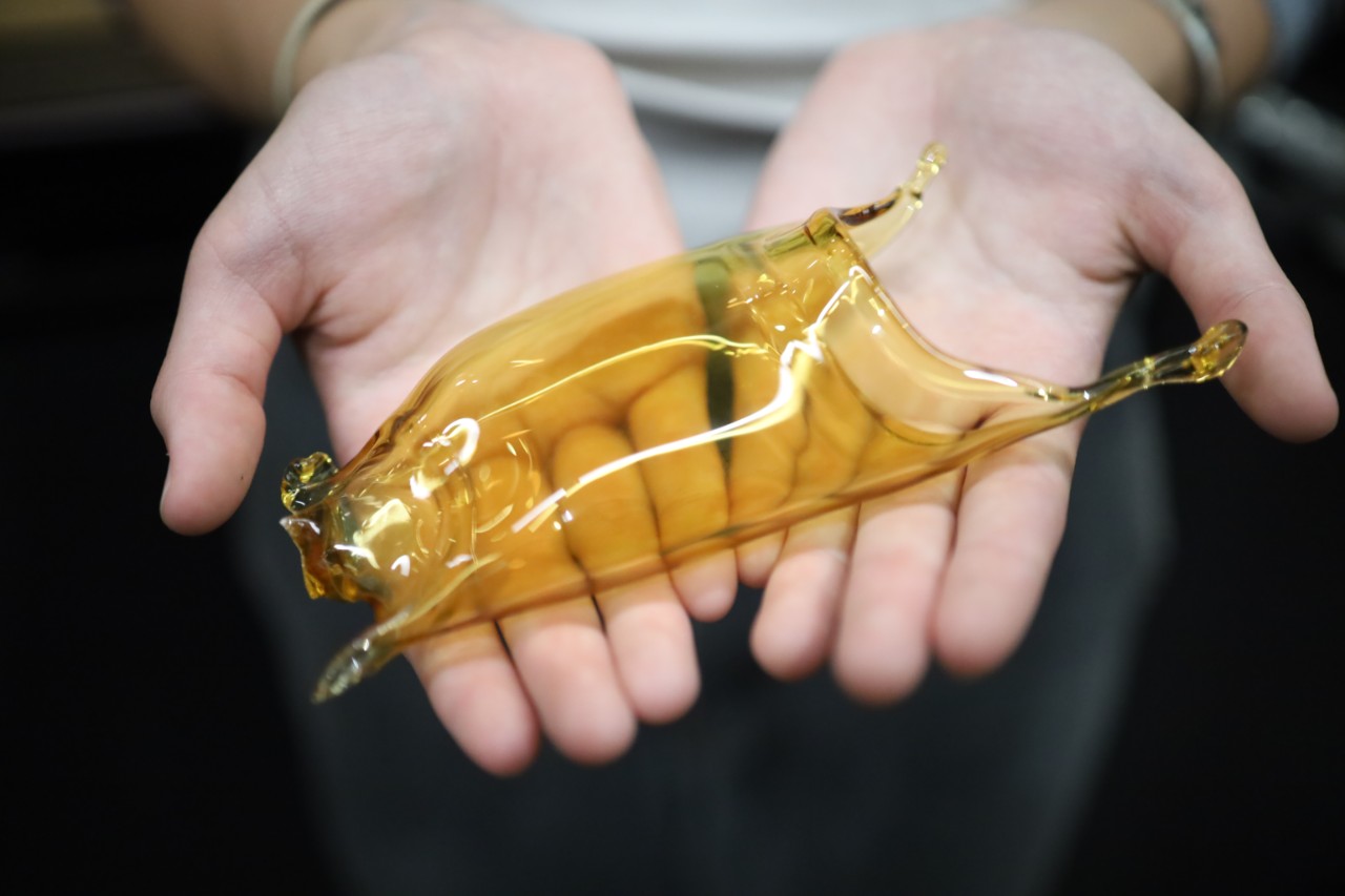 glass artwork being held in two hands