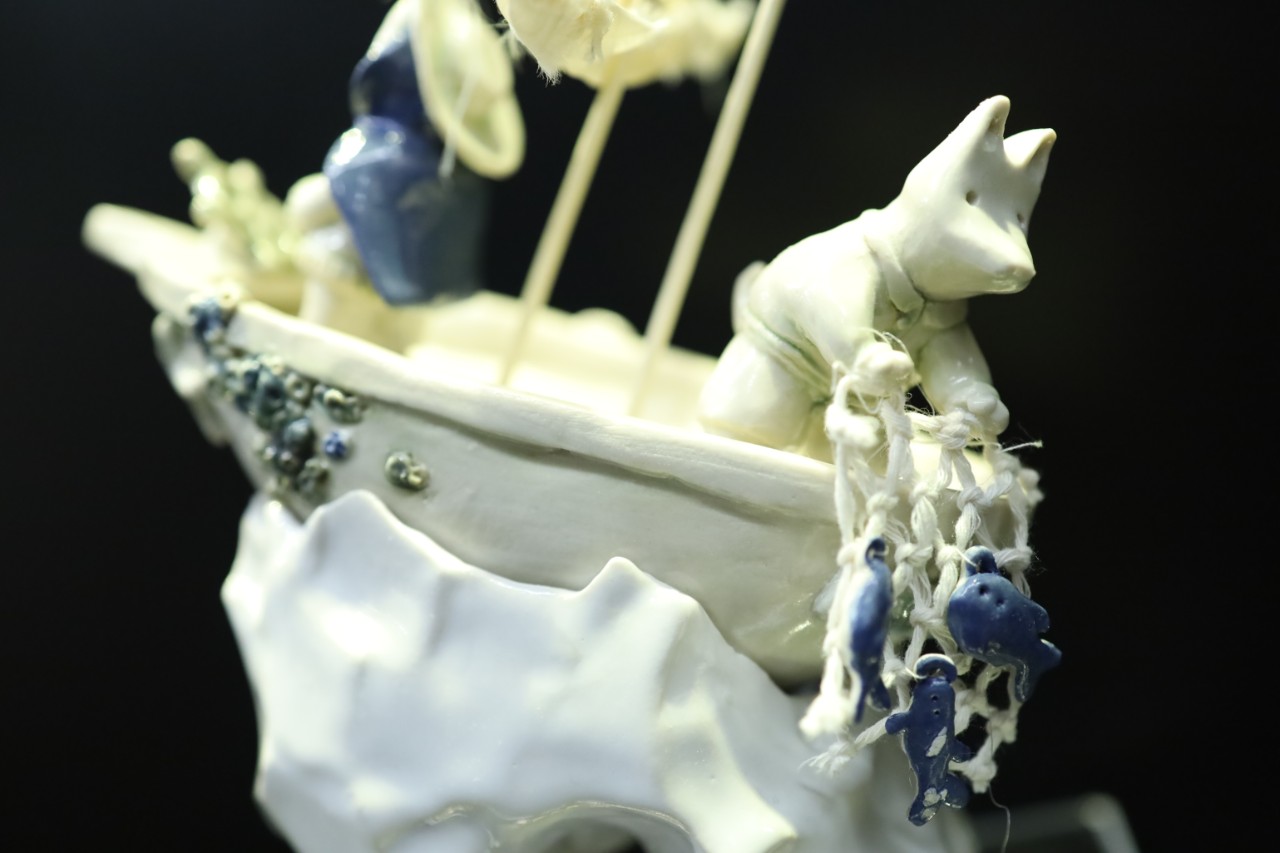 ceramic statue figurine of a cat on a ship