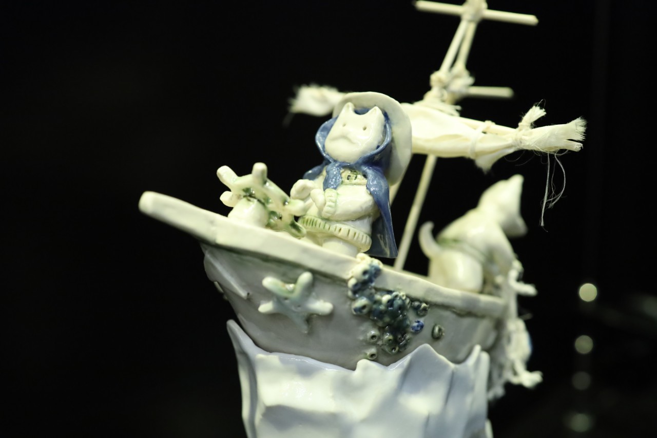 ceramic artwork of a cat in a ship