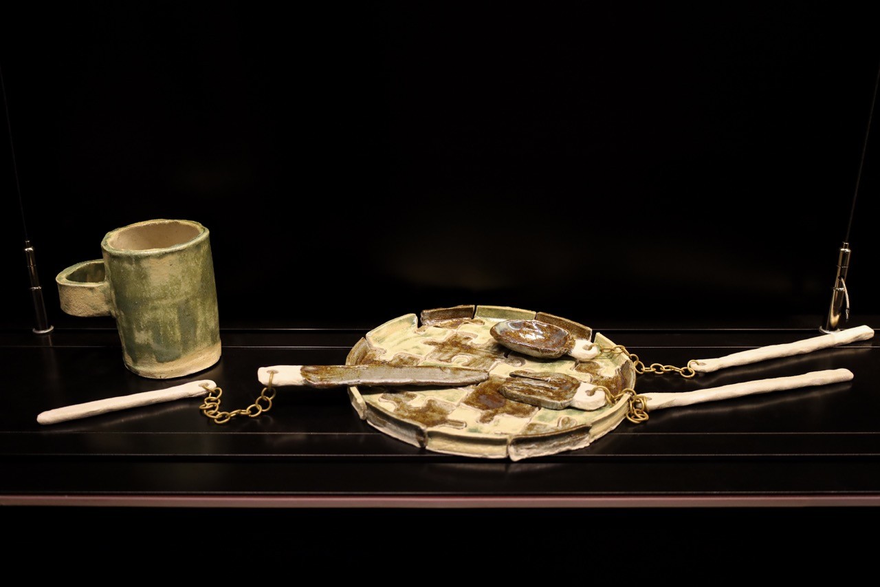 Close up of ceramic works in a glass display cabinet