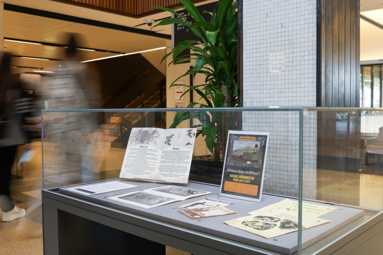 Books on display in a glass cabinet