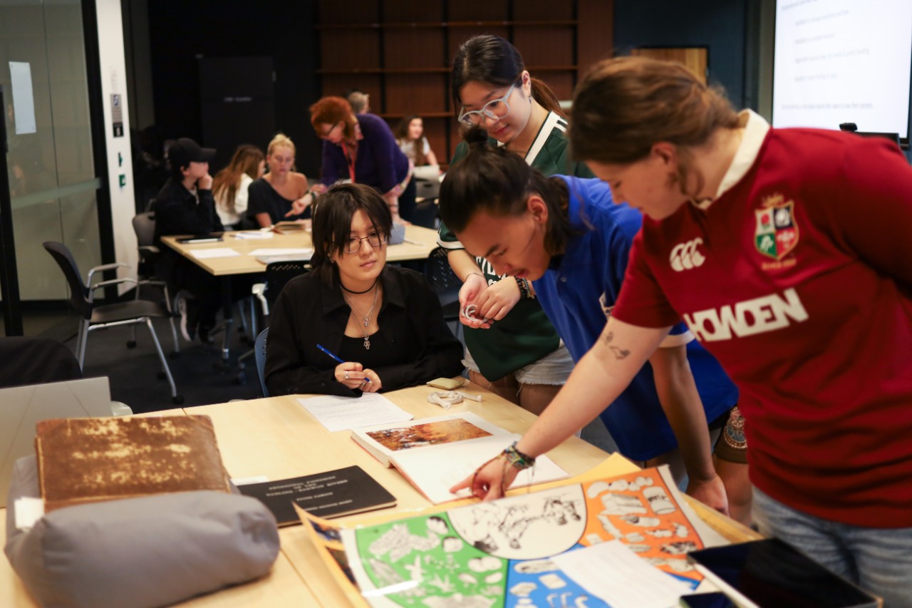 Students in an object based learning class looking at collection material