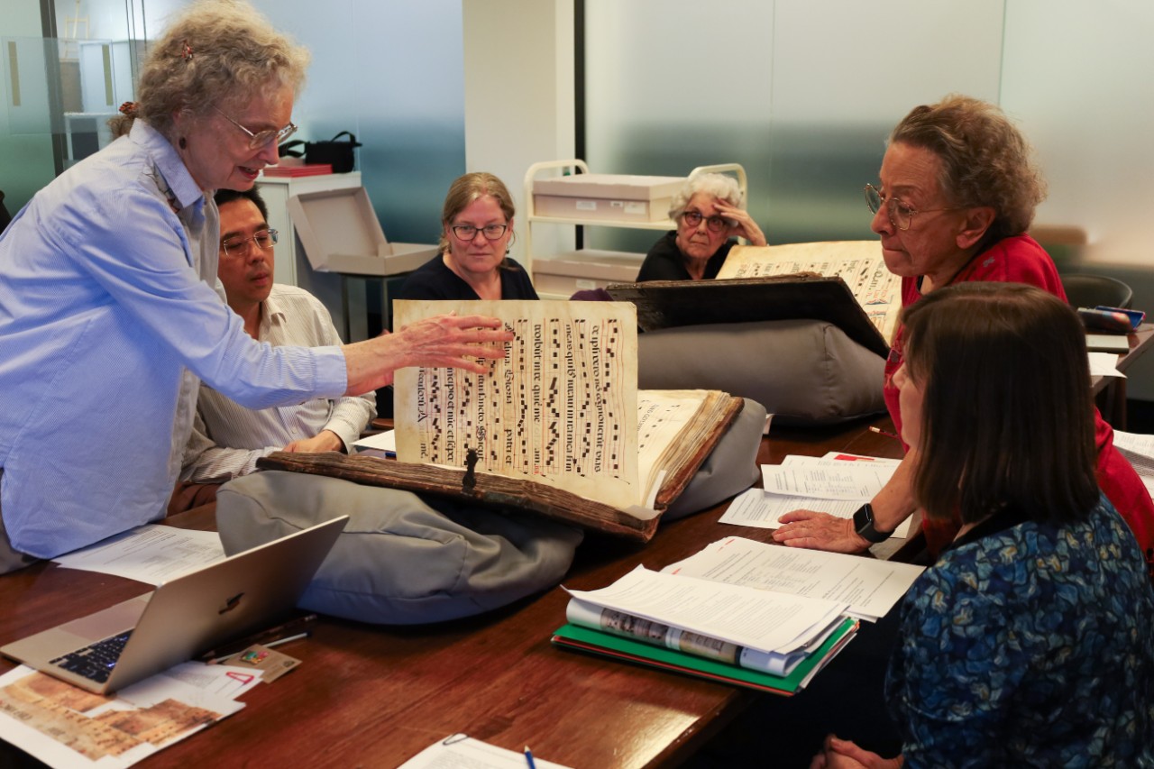 Group viewing a liturgical manuscript