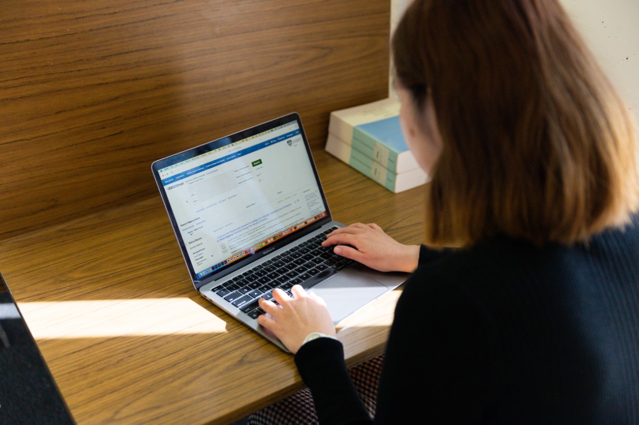 Person working on laptop at a desk