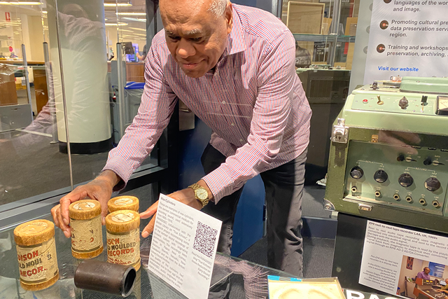 Curator installing objects for an exhibition