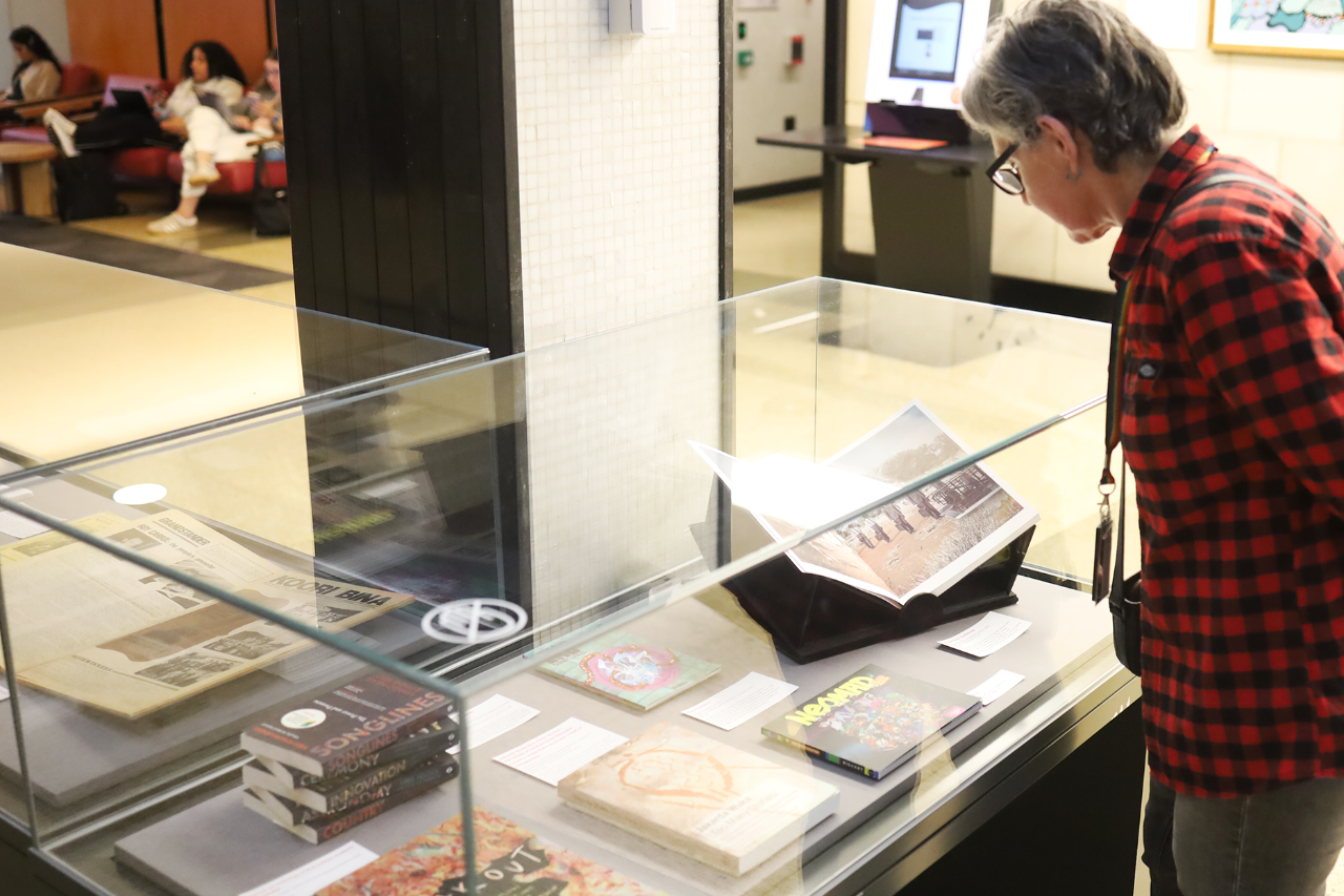 a person leaning over to view an exhibition on display