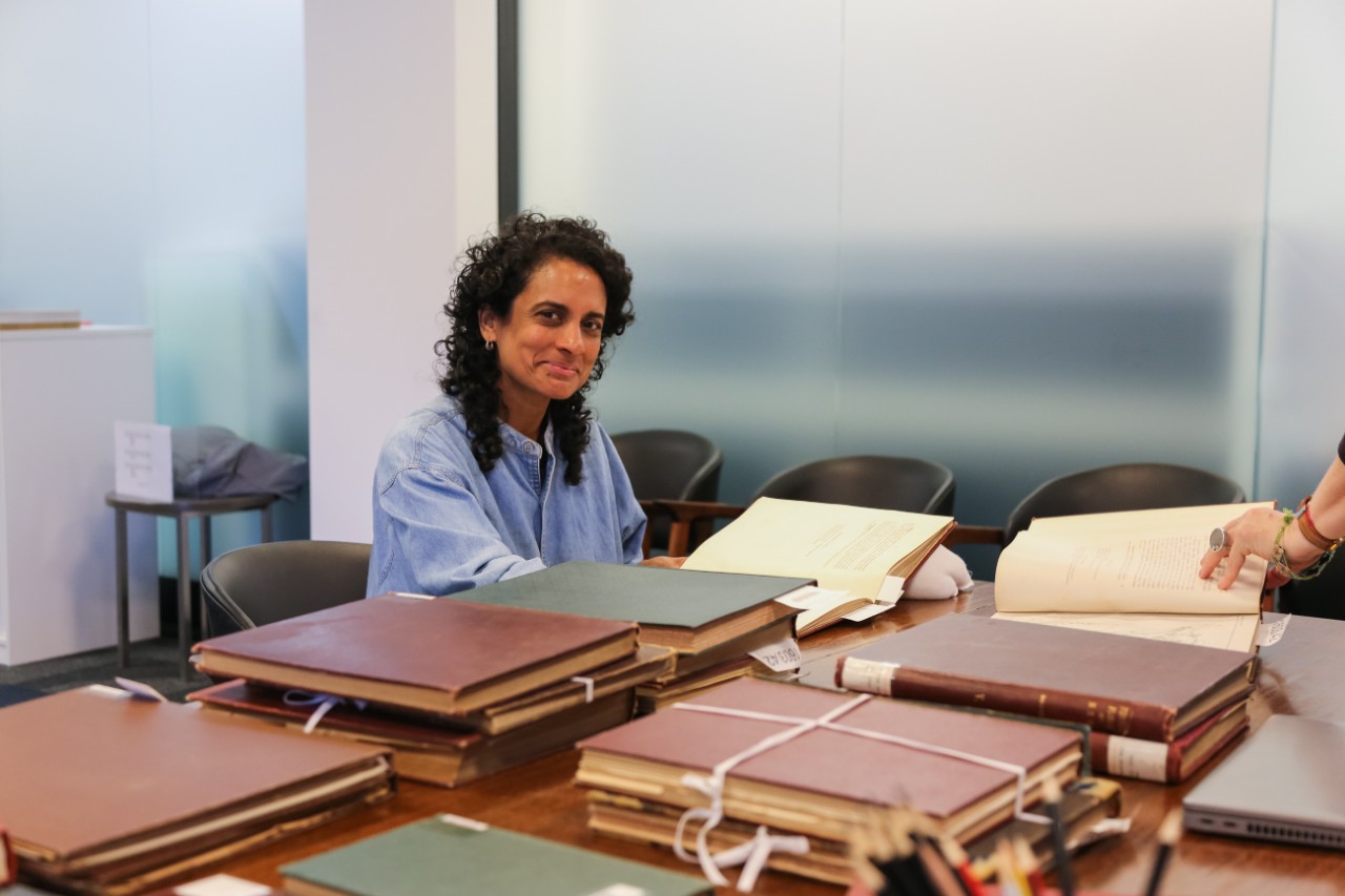Keg de Souza browsing books in Rare Books and Special Collections