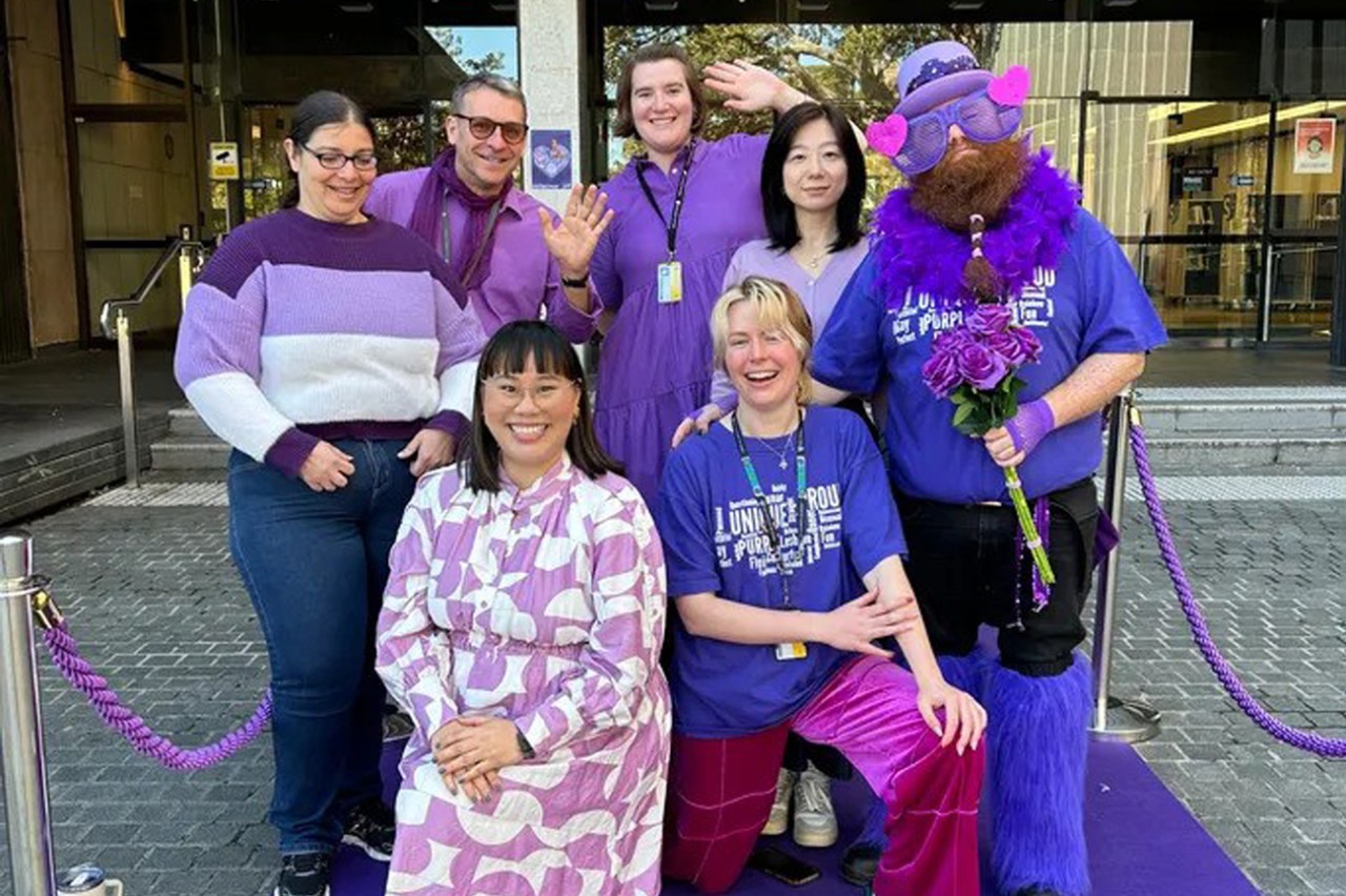 library staff on purple carpet