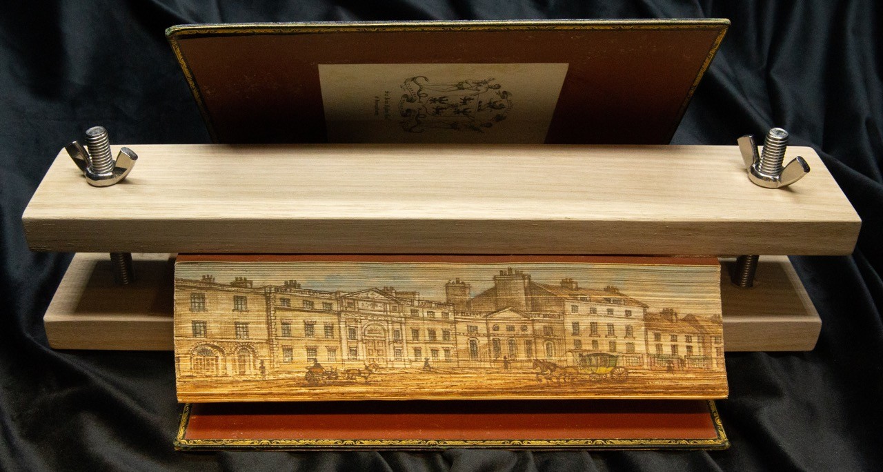 Fore-edge painting on a book, held in place with a clamp