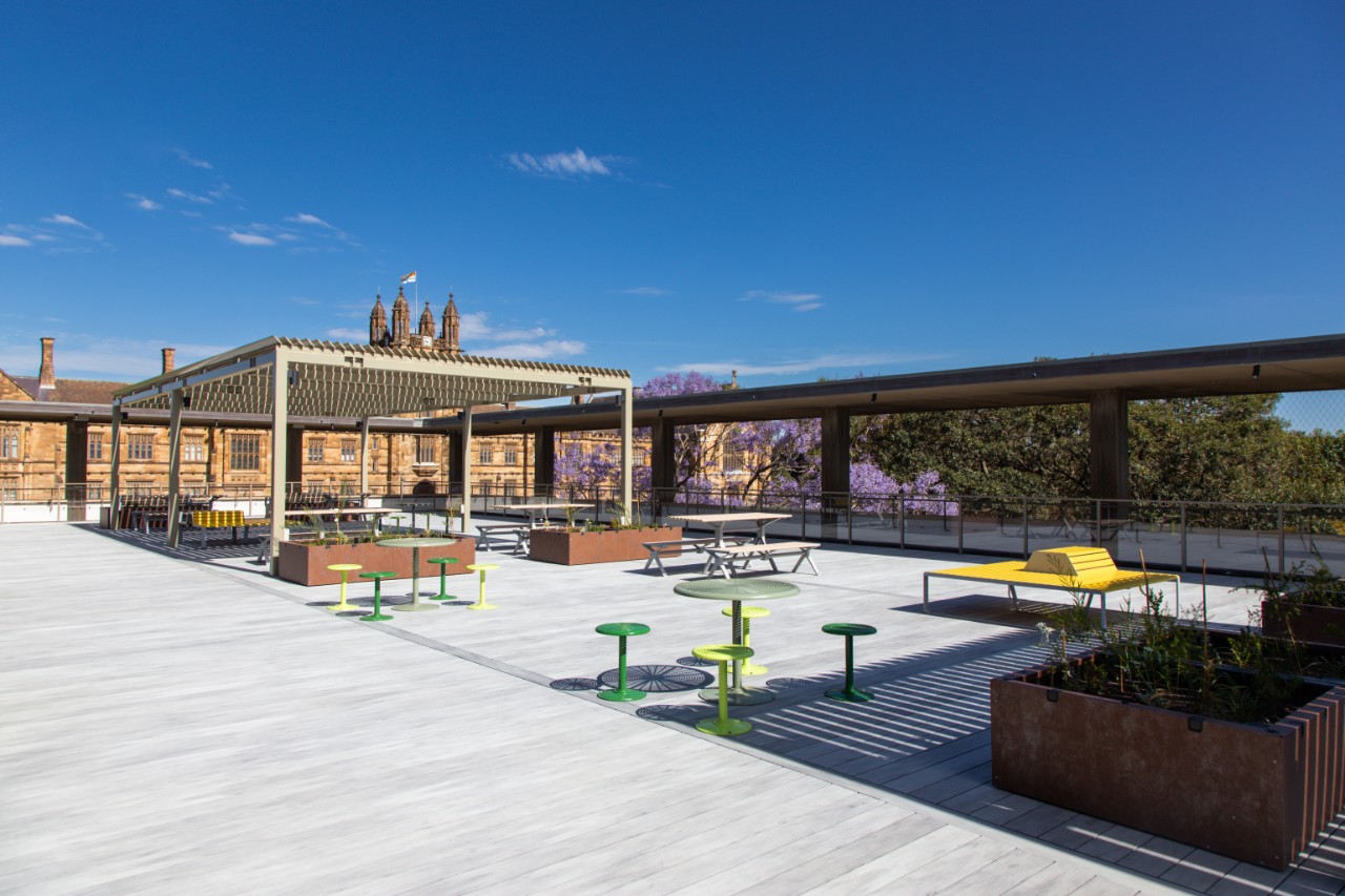 An image of the reopened Fisher rooftop terrace with the Quadrangle in the background.