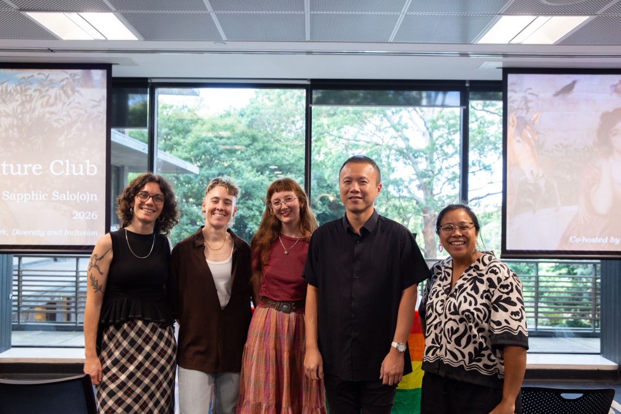 A photograph of five people, the MCs and speakers from the event-left to right, Caitlin Erbacher, Alexandra Pinkham, Olivia Sutherland, Gavin Lee, and Brooklyn Sulaemon. 