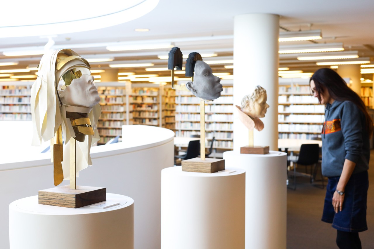 Three sculptures displayed on plinths in the Conservatorium Library